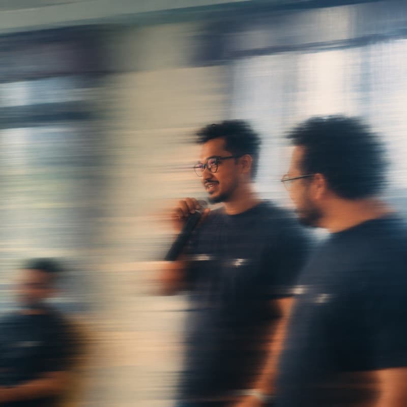 Speaking into a microphone at an indoor meet-up